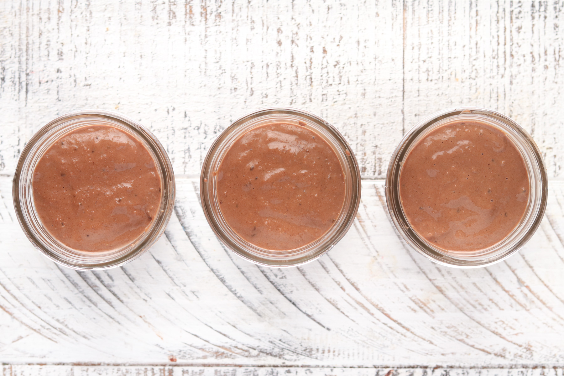 Step 2 - Chocolate Blended Overnight Oats divided into mason jars. 