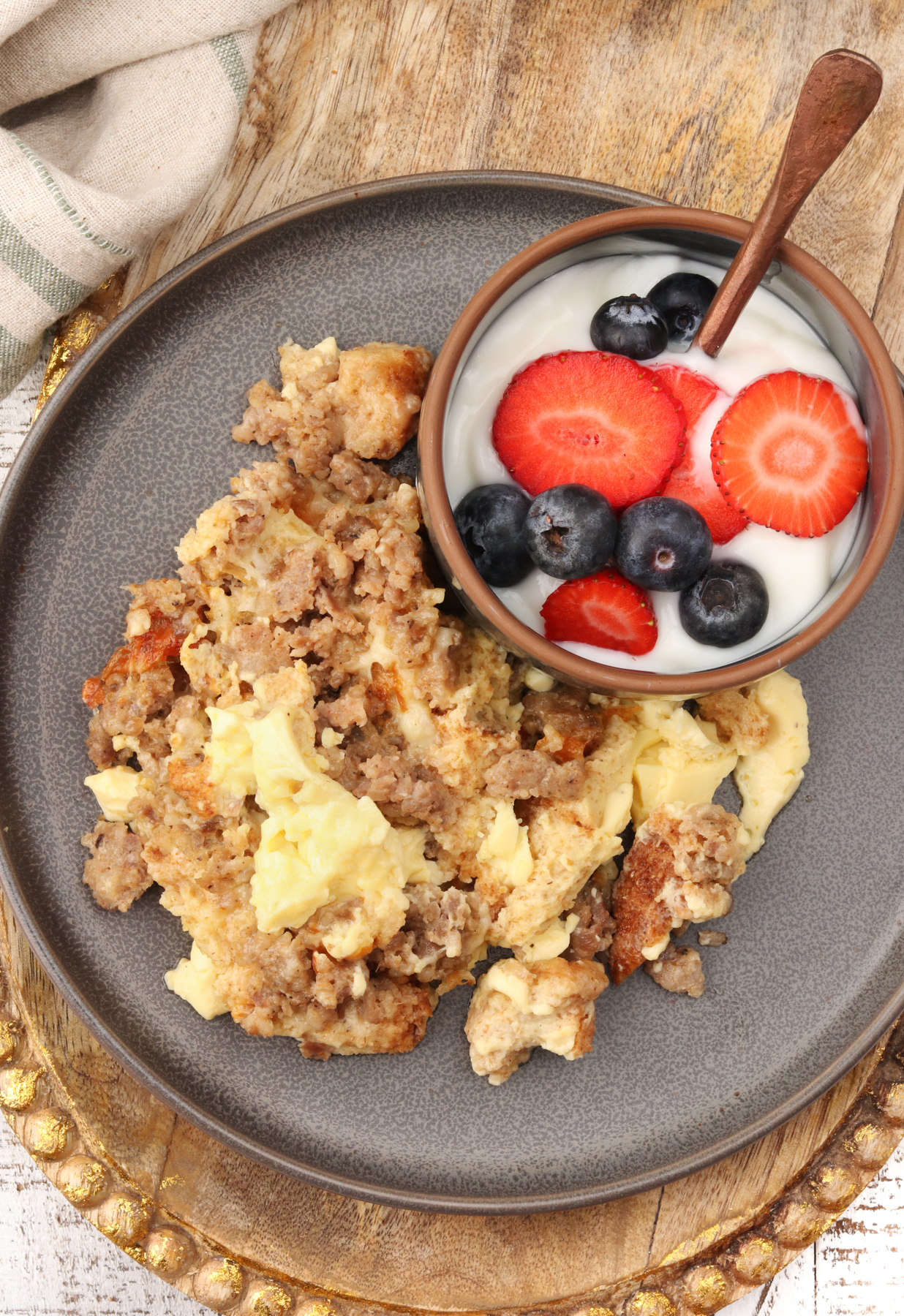 Cottage Cheese Egg Bake on a gray plate with a yogurt parfait.