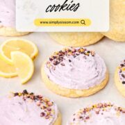 Lemon Blueberry Cookies on a sheet pan with lemons and fresh blueberries.