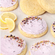Lemon Blueberry Cookies on a sheet pan with lemons and fresh blueberries.