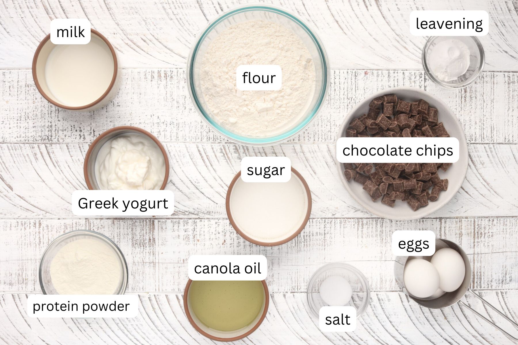 Ingredients - Chocolate Protein Muffins. Sugar, flour, salt, protein powder, eggs, chocolate chips, oil, leavening agents and Greek yogurt.