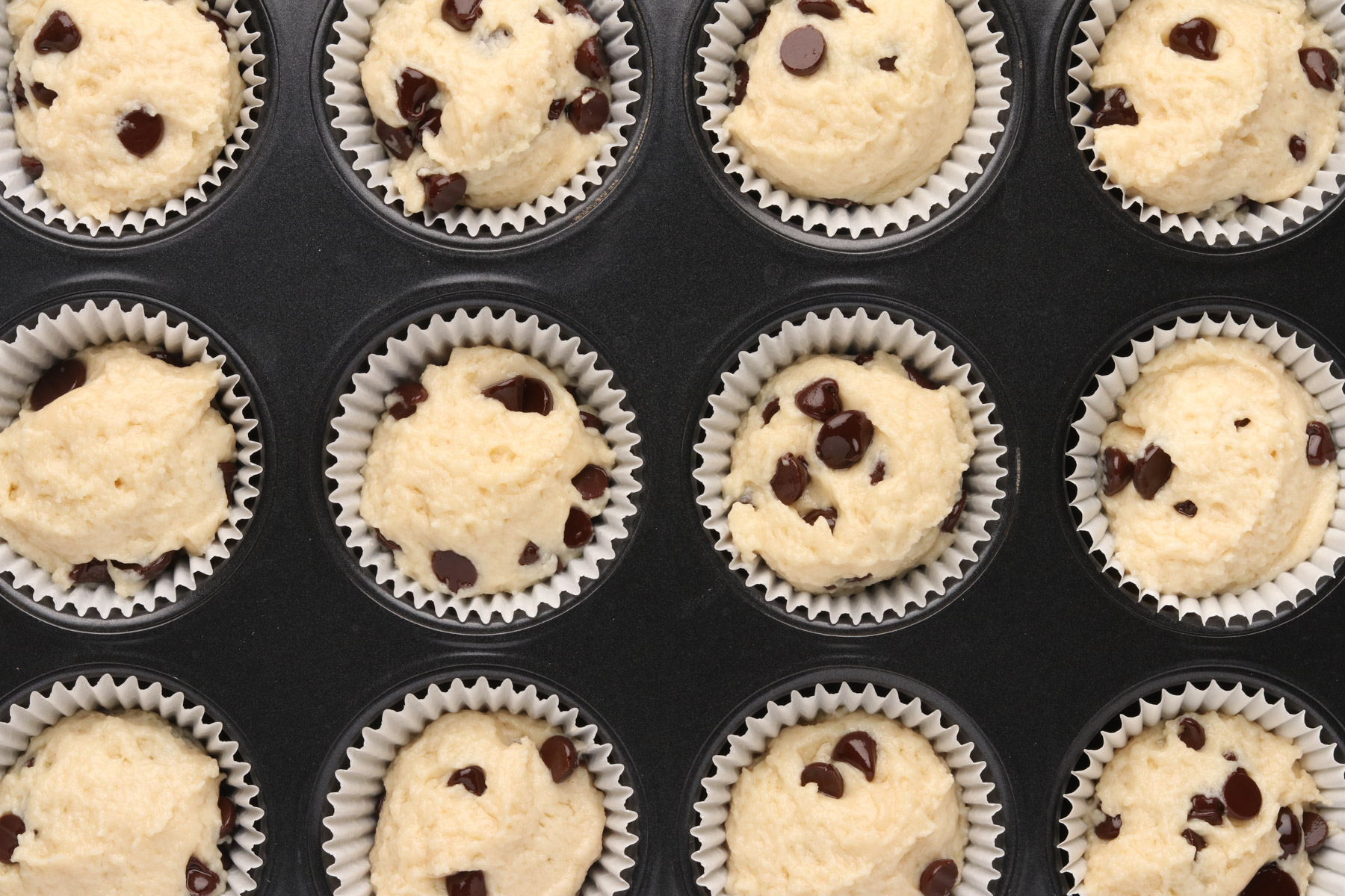 Step 5 - Chocolate Chip Protein Muffins. Scoop protein muffin batter into lined muffin cups. 