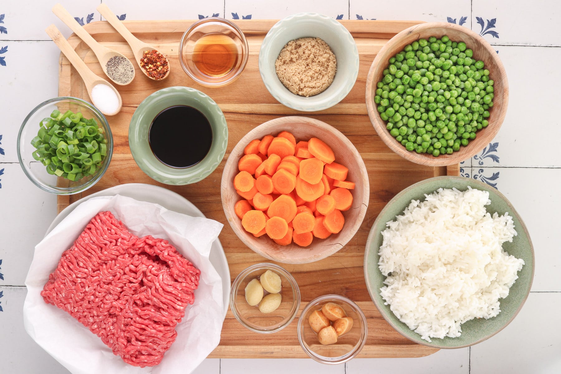 quick korean beef bowl ingredients on a wood cutting board.