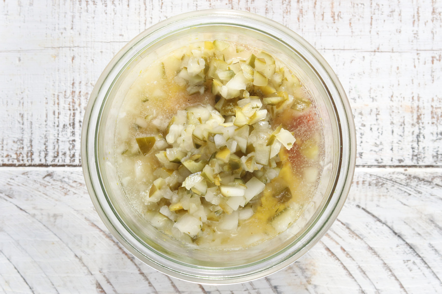 burger sauce ingredients mixed in a bowl with chopped pickles for burger bowls