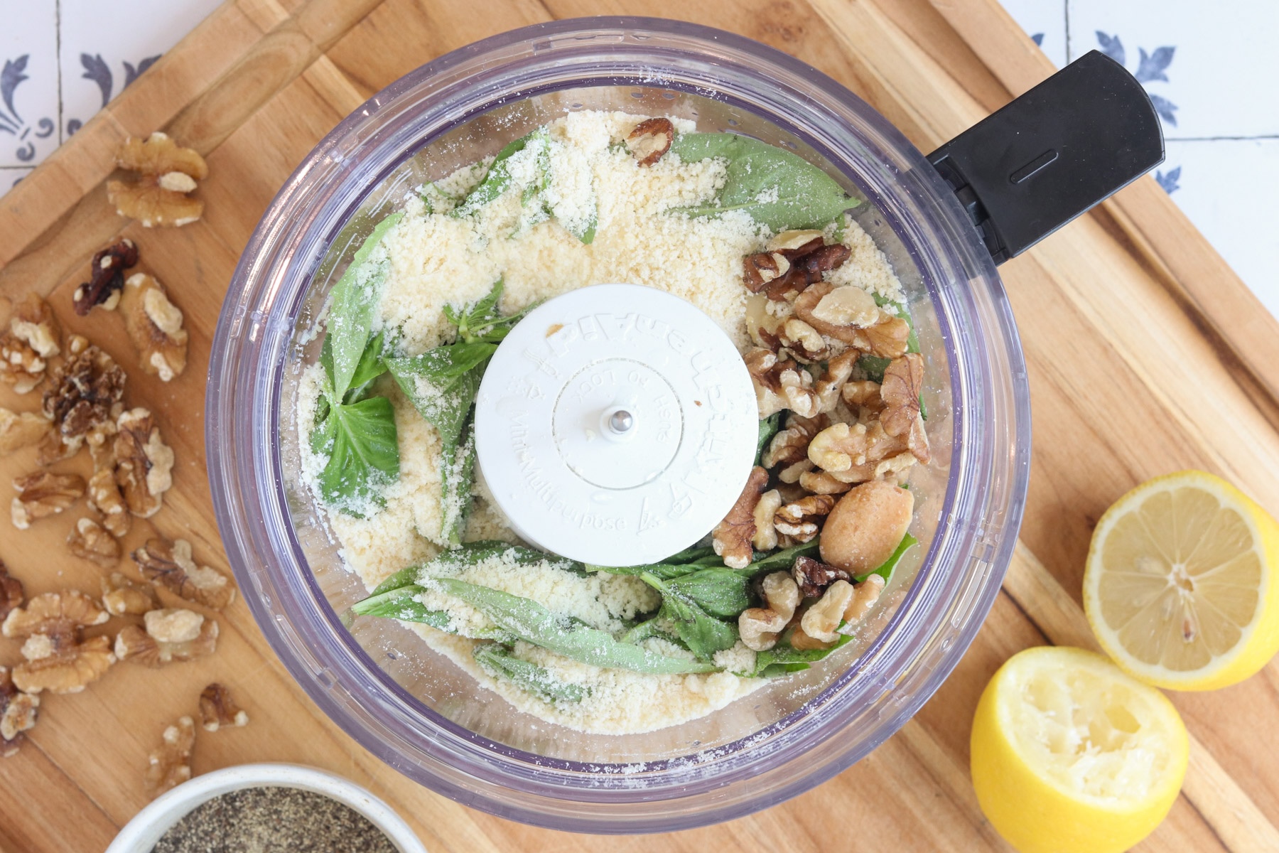 Fresh basil, grated Parmesan, walnuts, and lemon in a food processor for homemade pesto mayo.