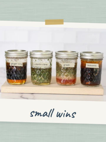 Four labeled jars of homemade chicken marinades — ginger-soy, cilantro-lime, Greek and balsamic — arranged on a wooden board.
